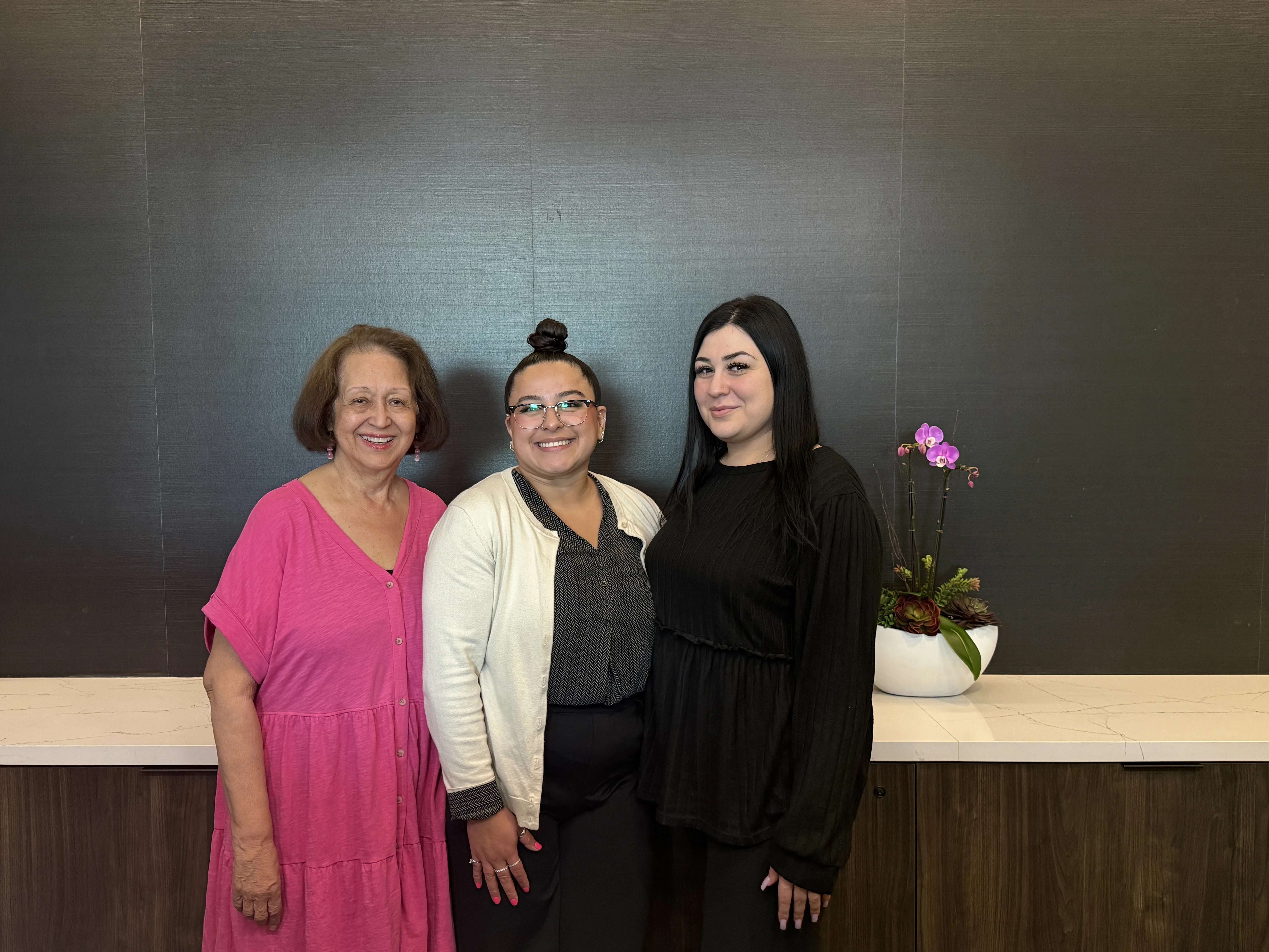 TSBA office staff Marie, Maria, and Lena standing together
